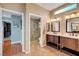 Bathroom showcasing double vanities with a walk-in shower and neutral colored walls and flooring at 2512 Desert Glen Dr, Las Vegas, NV 89134