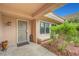 Covered porch featuring security door, xeriscaped yard with rock ground cover and desert plants at 2512 Desert Glen Dr, Las Vegas, NV 89134