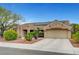 A charming single-story home with a tile roof, solar panels, and a well-maintained xeriscaped front yard at 2512 Desert Glen Dr, Las Vegas, NV 89134