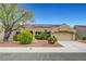 Charming single-story home featuring a tile roof, solar panels, and a well-manicured xeriscaped front yard at 2512 Desert Glen Dr, Las Vegas, NV 89134
