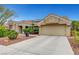 A charming single-story home with a tile roof, solar panels, a two car driveway and xeriscaped front yard at 2512 Desert Glen Dr, Las Vegas, NV 89134