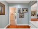 Bright hallway with wood floors, gallery wall, and access to other rooms in the house at 2512 Desert Glen Dr, Las Vegas, NV 89134