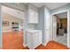 Hallway view with hardwood floors, built-in cabinets, and seamless access to other rooms at 2512 Desert Glen Dr, Las Vegas, NV 89134