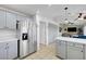 Open kitchen with stainless steel appliances, gray cabinets, and tile flooring at 2512 Desert Glen Dr, Las Vegas, NV 89134