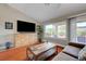 Modern living room with a large window, TV, and comfortable seating arrangement at 2512 Desert Glen Dr, Las Vegas, NV 89134