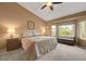 Spacious main bedroom featuring a bay window, ceiling fan, and neutral decor at 2512 Desert Glen Dr, Las Vegas, NV 89134