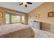 Relaxing main bedroom features plush carpeting, a ceiling fan, and a bay window for natural light at 2512 Desert Glen Dr, Las Vegas, NV 89134