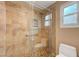 Shower with mosaic tile, glass enclosure, and a window providing natural light at 2512 Desert Glen Dr, Las Vegas, NV 89134