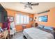 Bedroom features a ceiling fan, carpeting, plantation shutters, and decor at 2707 Commitment Ct, North Las Vegas, NV 89031