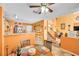 Open-concept dining area with a ceiling fan and orange-painted walls at 2707 Commitment Ct, North Las Vegas, NV 89031