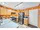 Functional kitchen with light wood cabinets, stainless steel appliances, and orange-painted walls at 2707 Commitment Ct, North Las Vegas, NV 89031