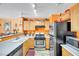 Well-lit kitchen featuring wooden cabinets, stainless steel appliances, and ample counter space at 2707 Commitment Ct, North Las Vegas, NV 89031