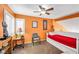 Living room with daybed, ceiling fan and natural light from bright window with shutter at 2707 Commitment Ct, North Las Vegas, NV 89031