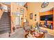 Cozy living room featuring a staircase and warm, orange-painted walls at 2707 Commitment Ct, North Las Vegas, NV 89031