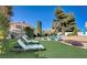 Relaxing backyard featuring a sparkling pool, lounge chairs, and well-maintained landscaping at 2714 Cricket Hollow Ct, Henderson, NV 89074