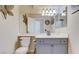 Bathroom showcasing gray cabinets, neutral walls and a large mirror at 2714 Cricket Hollow Ct, Henderson, NV 89074