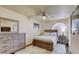 Cozy bedroom with a ceiling fan, area rug, and wood furnishings, including a queen-sized bed at 2714 Cricket Hollow Ct, Henderson, NV 89074