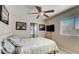 Comfortable bedroom with ceiling fan, window and ensuite bathroom access at 2714 Cricket Hollow Ct, Henderson, NV 89074