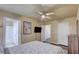 Bedroom featuring a ceiling fan, television, access to other rooms, and neutral tones at 2714 Cricket Hollow Ct, Henderson, NV 89074