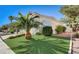 Beautiful landscaping with a mature palm tree complementing the home's exterior at 2714 Cricket Hollow Ct, Henderson, NV 89074
