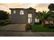 Two-story home with a well-manicured lawn, mature palm tree, and a driveway at 2714 Cricket Hollow Ct, Henderson, NV 89074