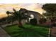 Well-maintained front yard with lush greenery and a beautiful palm tree in front of the house at 2714 Cricket Hollow Ct, Henderson, NV 89074