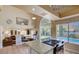 An open floorplan connects the kitchen to the living room and backyard pool access at 2714 Cricket Hollow Ct, Henderson, NV 89074