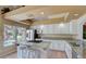 Bright kitchen featuring granite countertops, breakfast bar, stainless appliances, and backyard view at 2714 Cricket Hollow Ct, Henderson, NV 89074