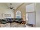 Comfortable living room with tile floors, large sectional sofa, ceiling fan, and neutral decor at 2714 Cricket Hollow Ct, Henderson, NV 89074