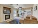 Spacious living room with fireplace, open to the kitchen, and access to the backyard pool at 2714 Cricket Hollow Ct, Henderson, NV 89074