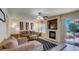 Cozy living room with fireplace, sliding glass door, and comfortable furnishings at 2714 Cricket Hollow Ct, Henderson, NV 89074