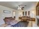 Bright living room featuring a comfortable sofa and a view into laundry room at 2714 Cricket Hollow Ct, Henderson, NV 89074