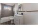 Bathroom showcasing a sink with countertop, a bathtub, and gray tiling at 2825 Hickey Ave, North Las Vegas, NV 89030