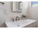 Bathroom featuring a sink with countertop, vanity, mirror, wall decor, and a window at 2825 Hickey Ave, North Las Vegas, NV 89030