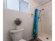 Bathroom featuring a walk in shower with a curtain, toilet, and neutral decor at 2825 Hickey Ave, North Las Vegas, NV 89030