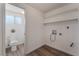 This bathroom/laundry room boasts floating shelves and modern fixtures at 2825 Hickey Ave, North Las Vegas, NV 89030