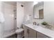 Bathroom featuring a sink, toilet, walk-in shower with white tiling, and a mirror at 2825 Hickey Ave, North Las Vegas, NV 89030