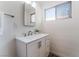 Bathroom showcasing a vanity with a sink, mirror, wall decor, and a window at 2825 Hickey Ave, North Las Vegas, NV 89030