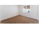 Bedroom featuring light brown carpet, a white wall, and a window with blinds at 2825 Hickey Ave, North Las Vegas, NV 89030