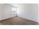 Cozy bedroom featuring neutral carpet, cinderblock wall, and natural light from window at 2825 Hickey Ave, North Las Vegas, NV 89030