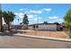 Charming single-story home with a gated yard, desert landscaping, and mature trees at 2825 Hickey Ave, North Las Vegas, NV 89030
