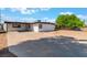 Long driveway leading to the front of the house with low maintenance landscaping and mature shade tree at 2825 Hickey Ave, North Las Vegas, NV 89030
