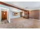 Open living room features a brick fireplace and carpeted flooring at 2825 Hickey Ave, North Las Vegas, NV 89030