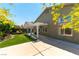 A view of the backyard showing a patio with cover, artificial grass and landscaping at 3300 Uribe St, Las Vegas, NV 89129