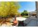 Inviting backyard oasis with covered patio, lush greenery, and charming seating area at 3300 Uribe St, Las Vegas, NV 89129