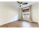 Bright bedroom featuring a modern ceiling fan, a large window, and neutral curtains at 3300 Uribe St, Las Vegas, NV 89129