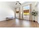 Sunlit bedroom featuring large windows, wood floors, and a modern ceiling fan at 3300 Uribe St, Las Vegas, NV 89129