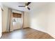 Bedroom featuring a modern ceiling fan, a large window, and neutral curtains at 3300 Uribe St, Las Vegas, NV 89129