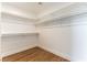 Walk-in closet with bright lighting, wood floors, and multiple shelves and bars at 3300 Uribe St, Las Vegas, NV 89129