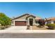 Charming single-story home with a well-maintained lawn and a two-car garage under a clear blue sky at 3300 Uribe St, Las Vegas, NV 89129